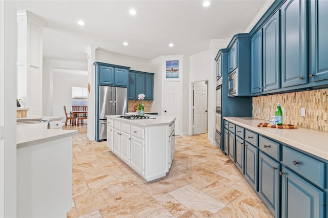 kitchen featuring blue cabinets, crown molding, a center island, appliances with stainless steel finishes, and backsplash