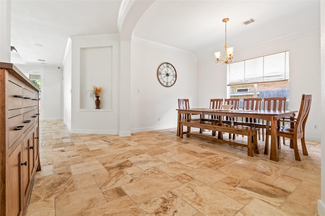 dining space featuring ornamental molding and a notable chandelier