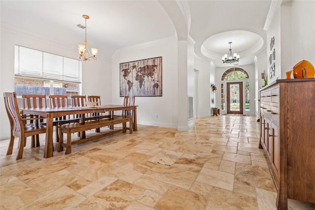 dining room with ornamental molding, french doors, a chandelier, and a high ceiling