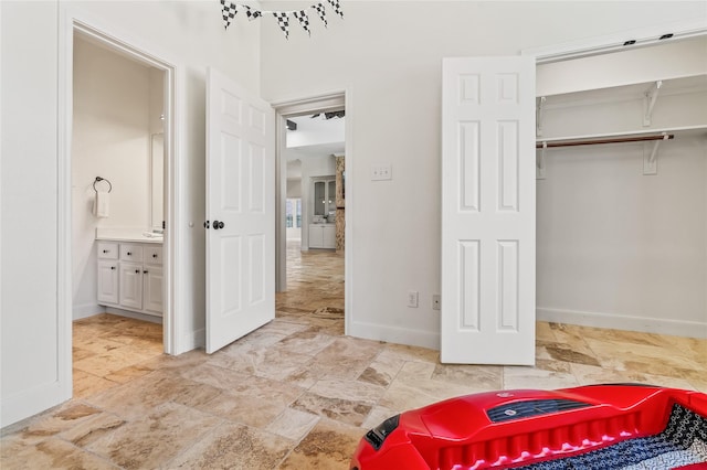 interior space with connected bathroom and a closet