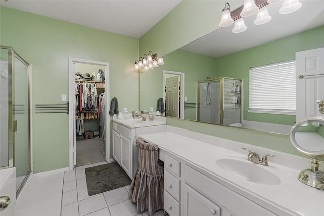 bathroom featuring vanity, a shower with shower door, and tile patterned floors