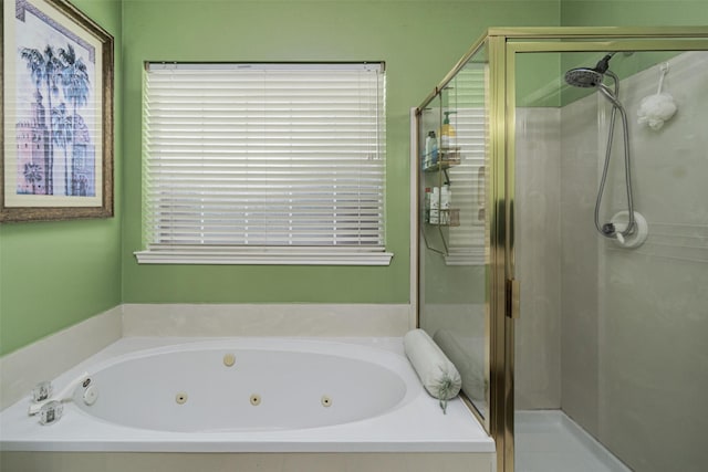 bathroom featuring separate shower and tub