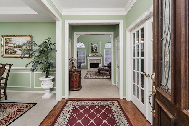 interior space with hardwood / wood-style floors, crown molding, and french doors