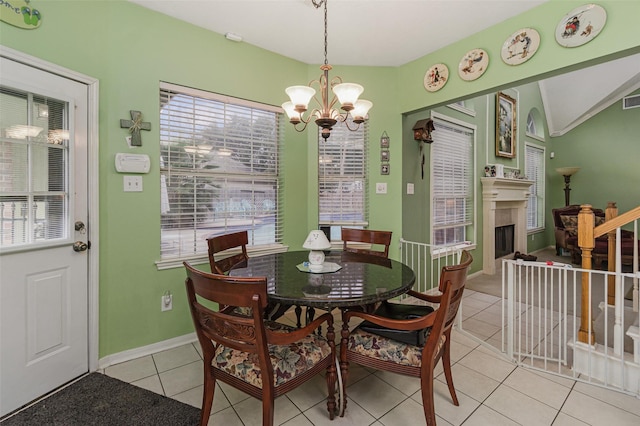 dining space with a chandelier and light tile patterned floors