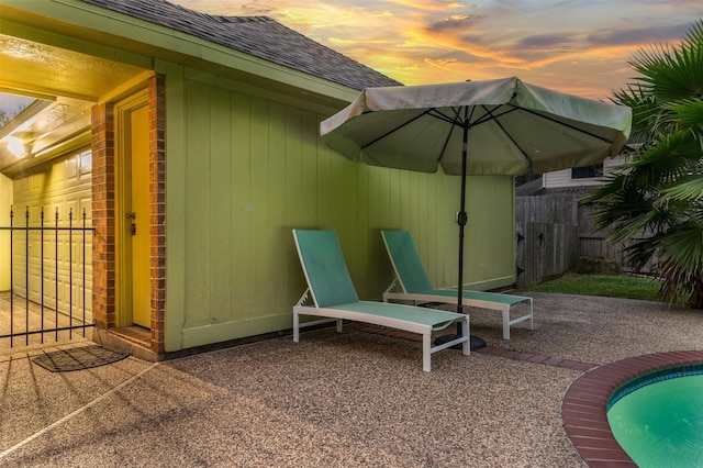 patio terrace at dusk with a swimming pool