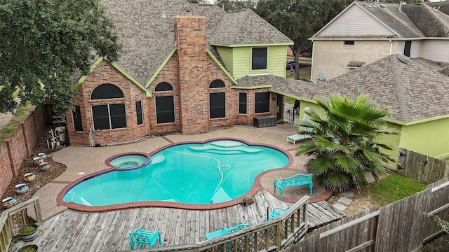 view of swimming pool with an in ground hot tub and a patio area