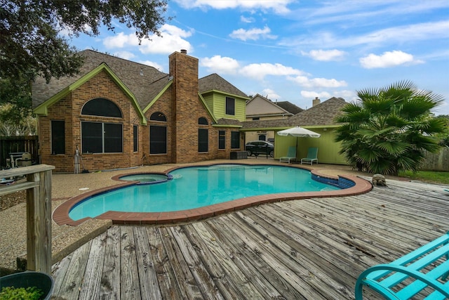 view of pool featuring an in ground hot tub and a deck