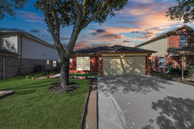 view of front of house featuring a lawn and a garage