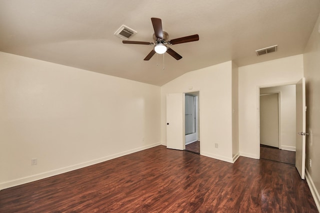 empty room featuring ceiling fan, lofted ceiling, and dark hardwood / wood-style floors