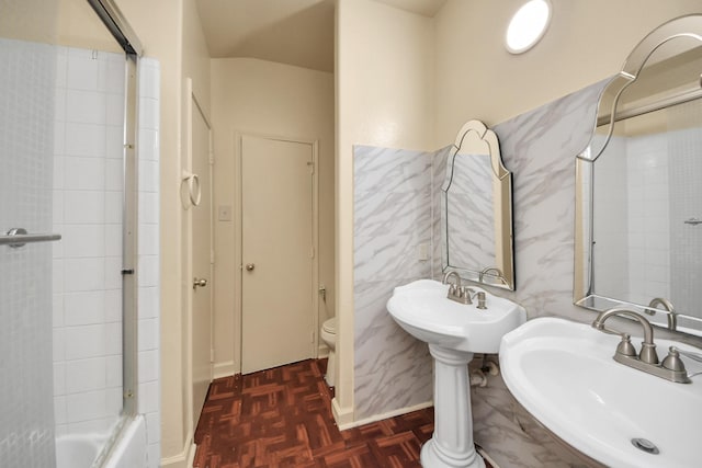 bathroom with shower / bathtub combination, parquet flooring, toilet, and double sink