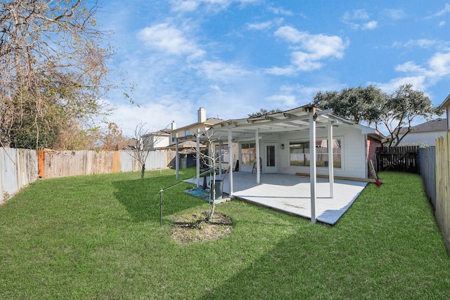 back of property with a lawn and a patio area