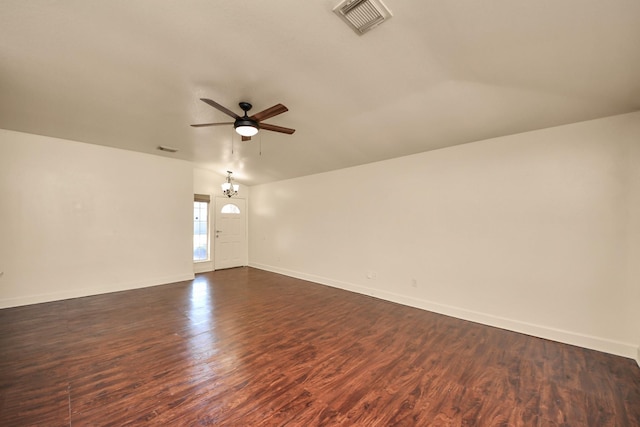 unfurnished room with ceiling fan with notable chandelier, dark wood-type flooring, and lofted ceiling