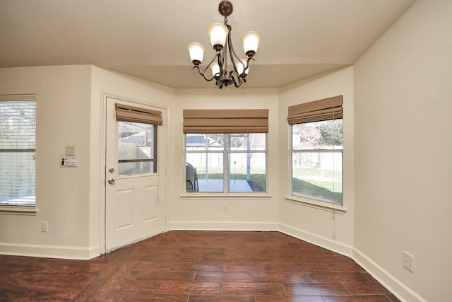 doorway featuring dark hardwood / wood-style flooring and a chandelier