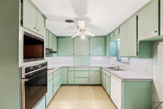 kitchen featuring ceiling fan, sink, white dishwasher, and wall oven