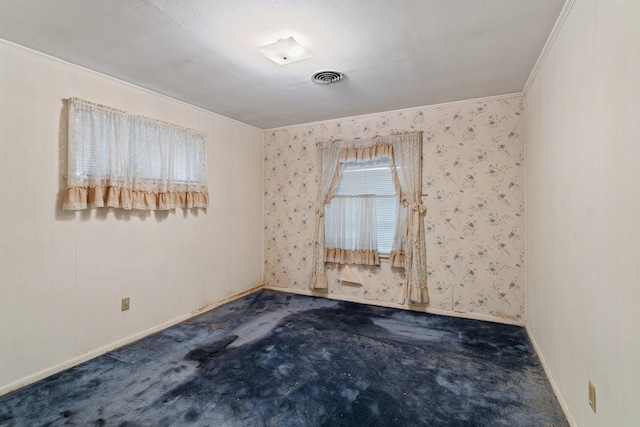 unfurnished room with crown molding and carpet flooring