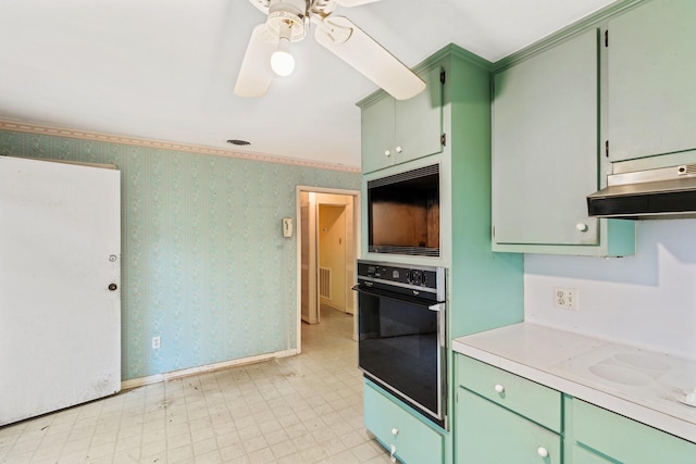 kitchen featuring white stovetop, ornamental molding, oven, ceiling fan, and green cabinets