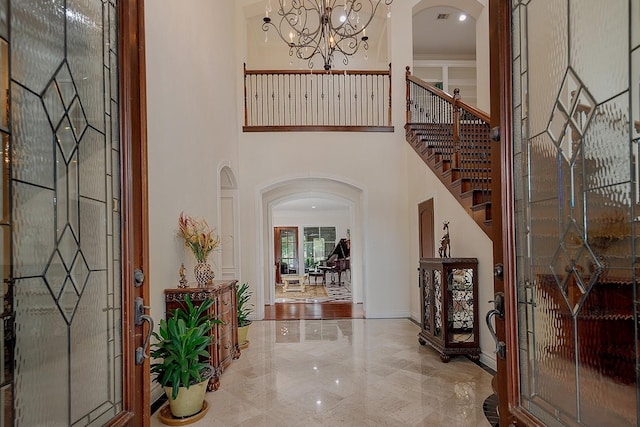 foyer entrance with a high ceiling and a chandelier