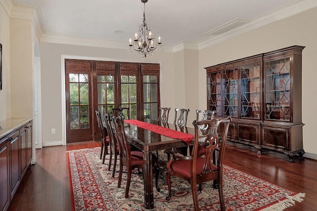 dining area featuring dark hardwood / wood-style flooring, a notable chandelier, crown molding, and french doors