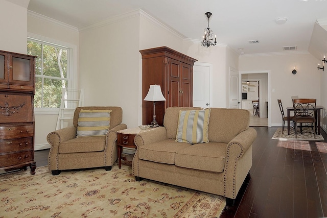 living room with an inviting chandelier, crown molding, and light hardwood / wood-style floors