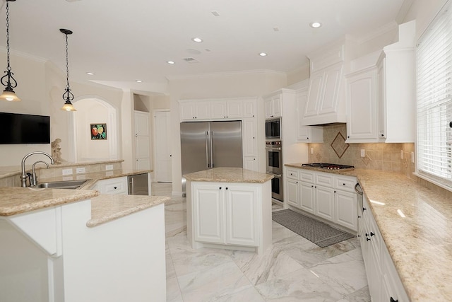 kitchen with white cabinetry, sink, and a center island