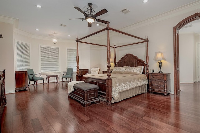 bedroom featuring ceiling fan, ornamental molding, and dark hardwood / wood-style floors