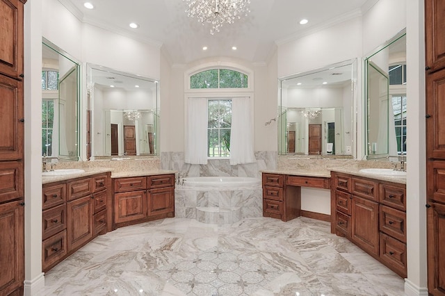 bathroom featuring tiled bath, vanity, a chandelier, and ornamental molding