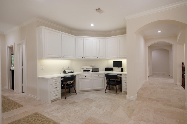 office space featuring ornamental molding and built in desk