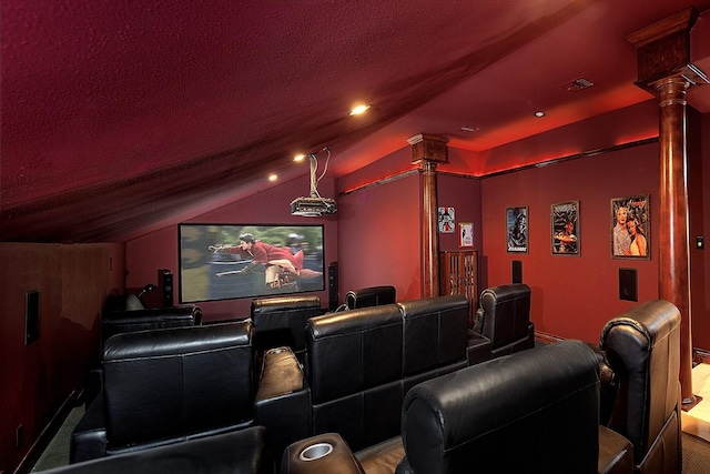 home theater with decorative columns and vaulted ceiling