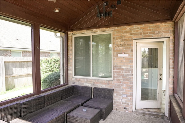 unfurnished sunroom with wooden ceiling and lofted ceiling