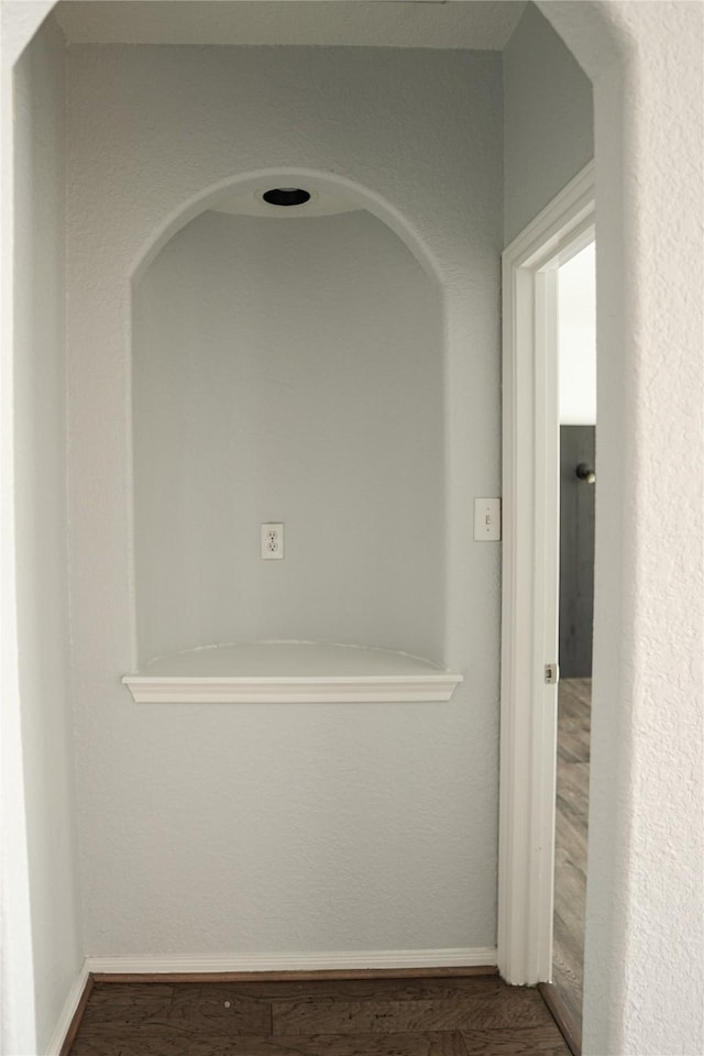 hallway with dark hardwood / wood-style flooring