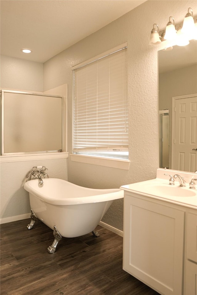 bathroom featuring hardwood / wood-style floors, independent shower and bath, and vanity