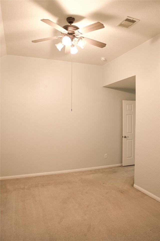 spare room with ceiling fan, light colored carpet, and lofted ceiling