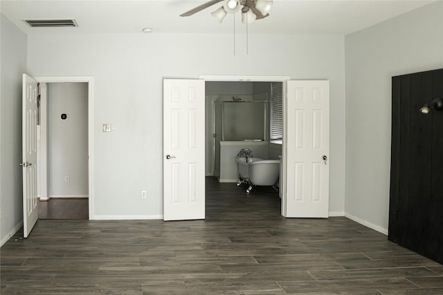 unfurnished bedroom with ceiling fan and dark wood-type flooring