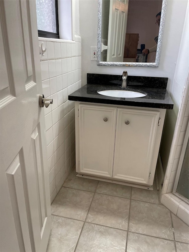3809 N Braeswood Blvd Unit 24, Houston, TX 77025 - bathroom with vanity, tile walls, and tile patterned floors