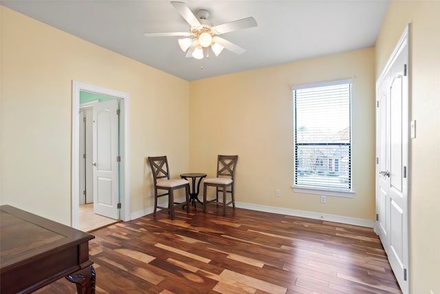 sitting room featuring ceiling fan and dark hardwood / wood-style floors