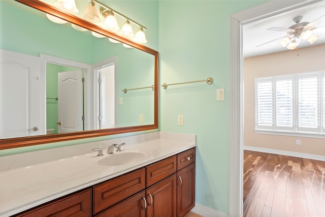 bathroom with ceiling fan, vanity, and hardwood / wood-style floors