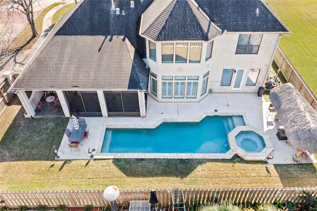 view of pool featuring an in ground hot tub, a patio area, and a lawn