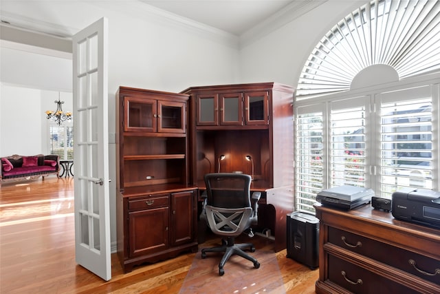 home office featuring french doors, a chandelier, crown molding, and light hardwood / wood-style flooring