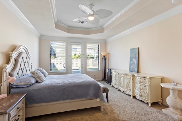 carpeted bedroom with ceiling fan, a tray ceiling, ornamental molding, and access to outside