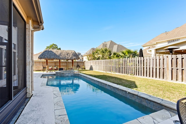 view of swimming pool with a patio area, an in ground hot tub, and a yard