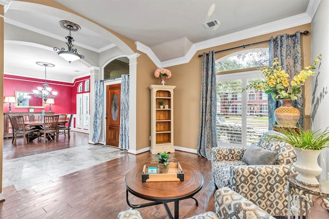 living room featuring ornamental molding, decorative columns, and wood-type flooring