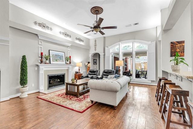 living room featuring hardwood / wood-style flooring and ceiling fan