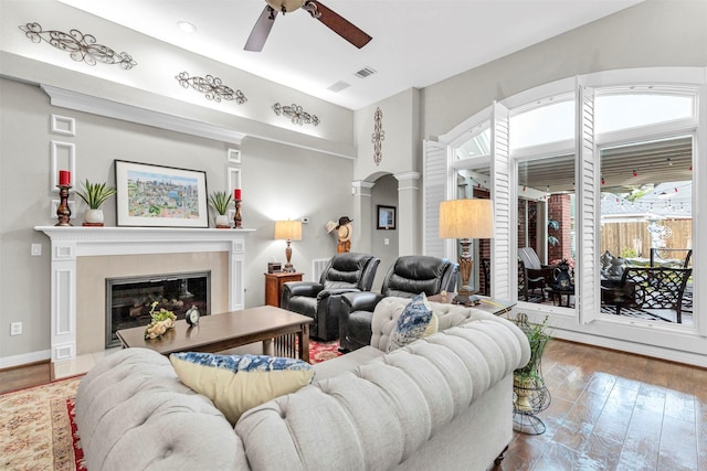 living room featuring ceiling fan, hardwood / wood-style floors, and ornate columns