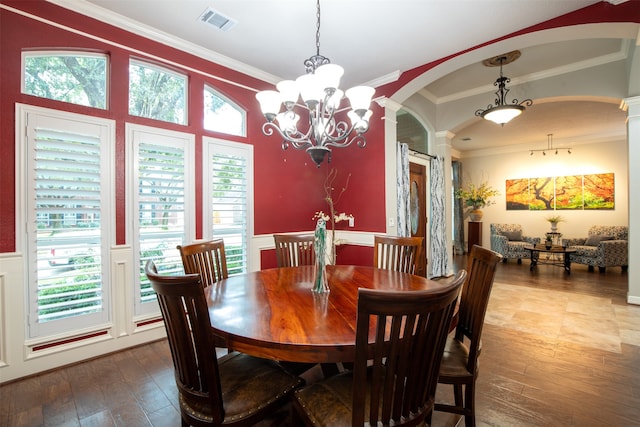 dining space with decorative columns, ornamental molding, wood-type flooring, and a wealth of natural light