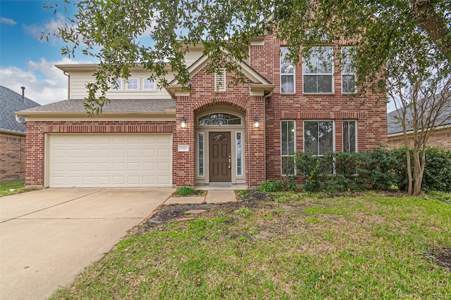 view of front of property featuring a front yard and a garage