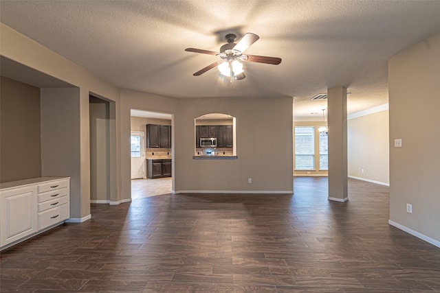 unfurnished living room with dark wood-type flooring, ceiling fan, and a textured ceiling