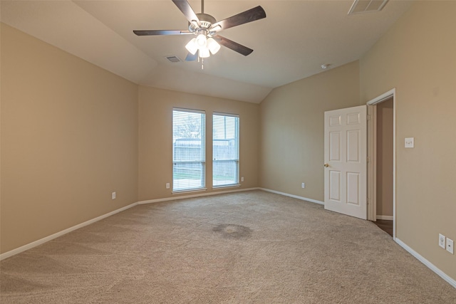 carpeted empty room featuring ceiling fan and lofted ceiling