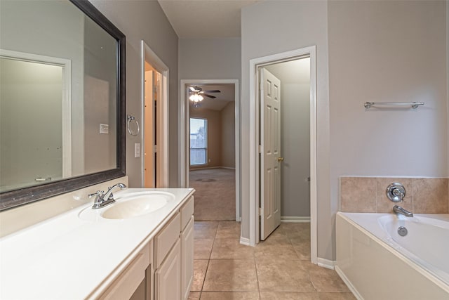 bathroom featuring a bath, ceiling fan, tile patterned flooring, and vanity