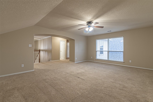 interior space with a textured ceiling, ceiling fan, and lofted ceiling