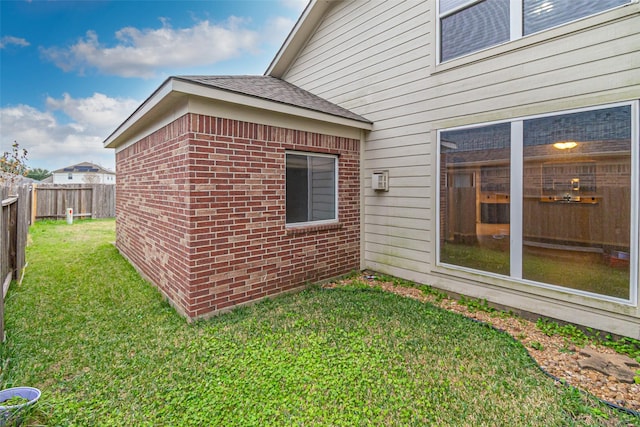 view of side of property with a yard